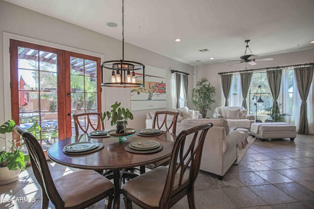 dining room with recessed lighting, french doors, ceiling fan with notable chandelier, visible vents, and stone tile flooring