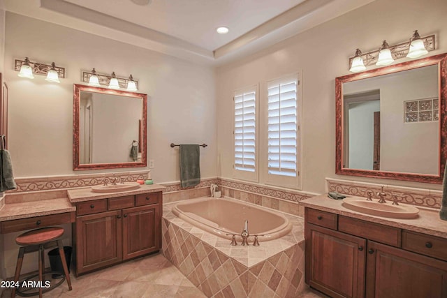 bathroom with a sink, two vanities, and a bath