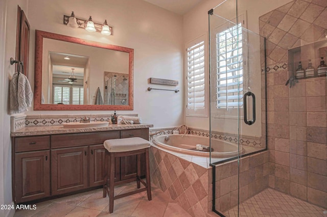 full bath with tile patterned floors, a ceiling fan, vanity, a stall shower, and a garden tub