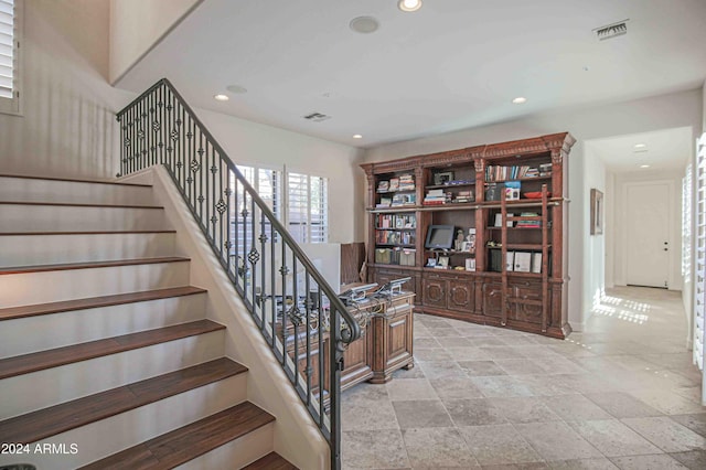 staircase with recessed lighting and visible vents