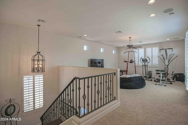 exercise room featuring carpet floors, ceiling fan with notable chandelier, recessed lighting, and visible vents