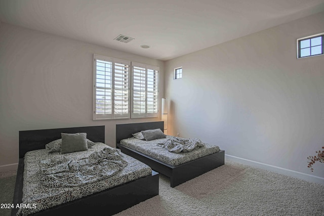 carpeted bedroom with baseboards and visible vents