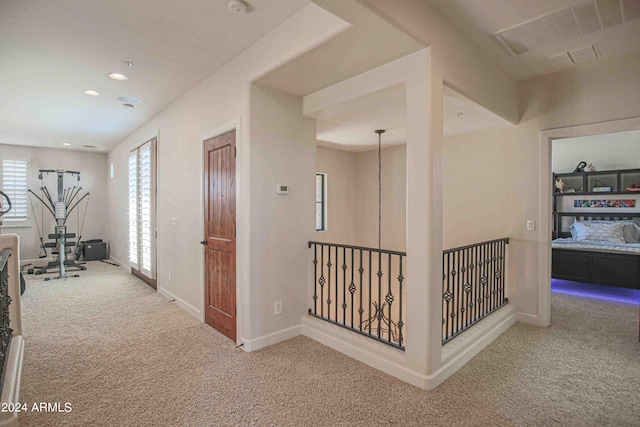 corridor with baseboards, recessed lighting, and carpet