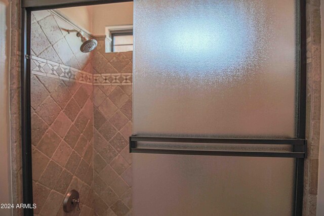 bathroom featuring a shower with shower door