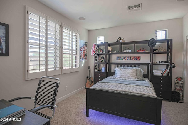 bedroom with multiple windows, visible vents, baseboards, and carpet