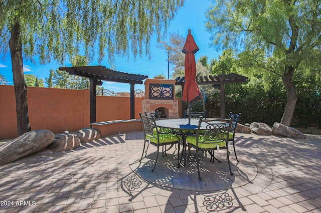 view of patio / terrace with a pergola, outdoor dining area, and exterior fireplace