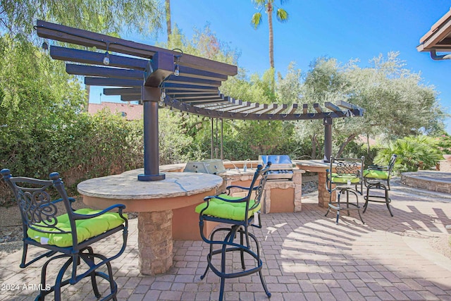 view of patio with outdoor dry bar, exterior kitchen, and a pergola