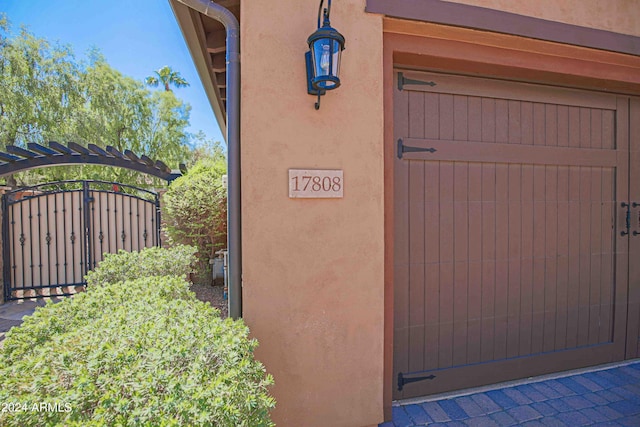 details featuring stucco siding and a gate