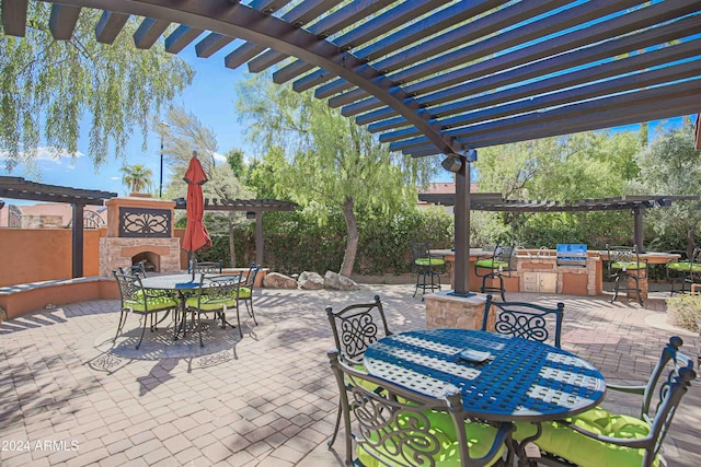 view of patio / terrace featuring outdoor dry bar, a pergola, exterior kitchen, an outdoor stone fireplace, and outdoor dining area