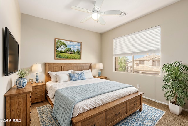 bedroom with ceiling fan and light colored carpet