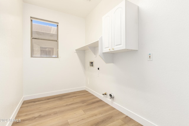 washroom featuring cabinets, hookup for a washing machine, gas dryer hookup, electric dryer hookup, and light hardwood / wood-style flooring