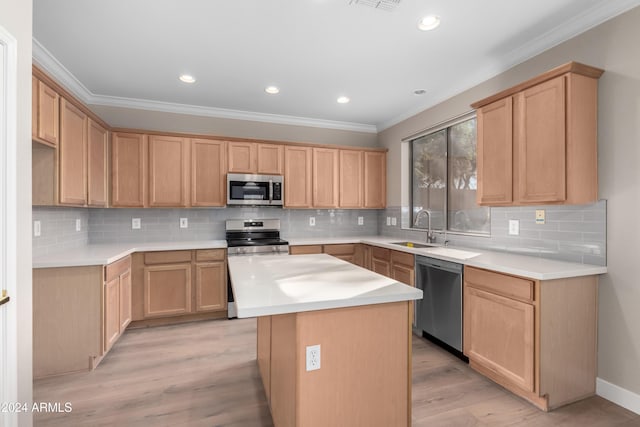 kitchen with light brown cabinets, a center island, sink, light wood-type flooring, and appliances with stainless steel finishes