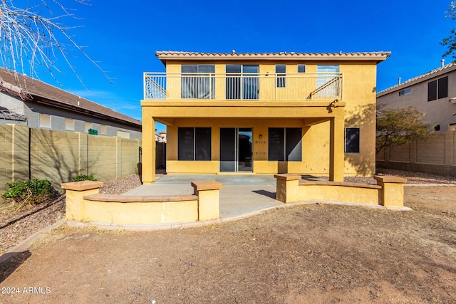 back of house featuring a patio and a balcony