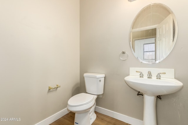 bathroom featuring sink, hardwood / wood-style floors, and toilet