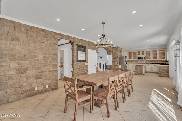 dining area with light tile patterned floors, arched walkways, a notable chandelier, recessed lighting, and ornamental molding