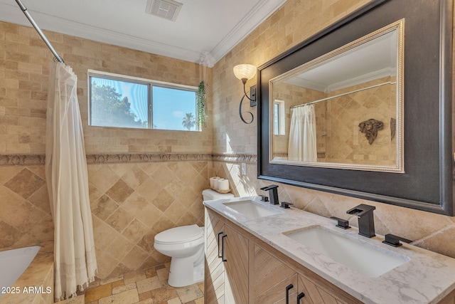 bathroom with visible vents, a sink, and ornamental molding