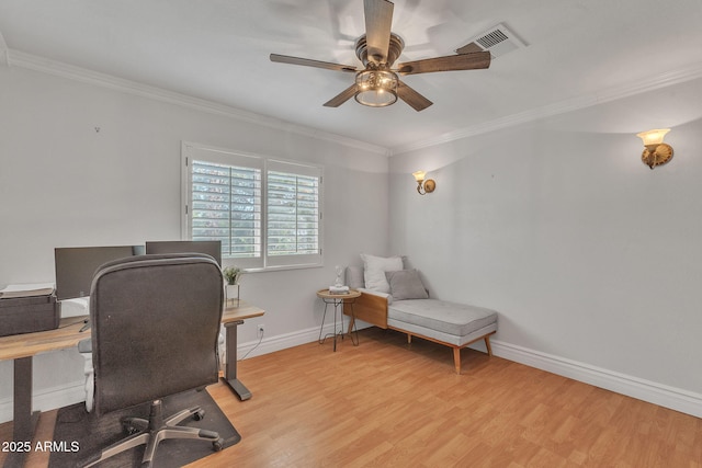 office featuring ornamental molding, light wood finished floors, visible vents, and baseboards