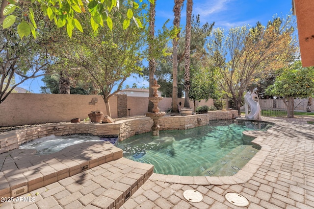 view of swimming pool with a patio area, a fenced backyard, a fenced in pool, and a water slide