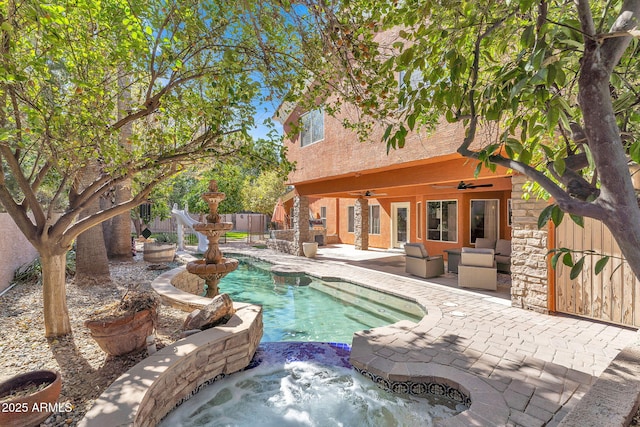 view of pool with fence, a ceiling fan, and a patio