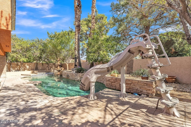 view of pool featuring a water slide, a patio area, a fenced backyard, and a fenced in pool