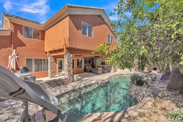 view of pool featuring a patio area, ceiling fan, and an outdoor living space