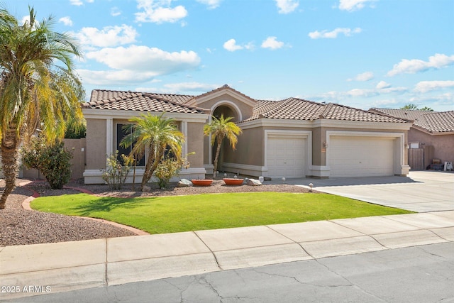 mediterranean / spanish house with a front yard and a garage