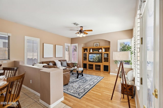 living room with ceiling fan and light hardwood / wood-style flooring