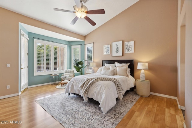 bedroom featuring ceiling fan, light hardwood / wood-style floors, and vaulted ceiling