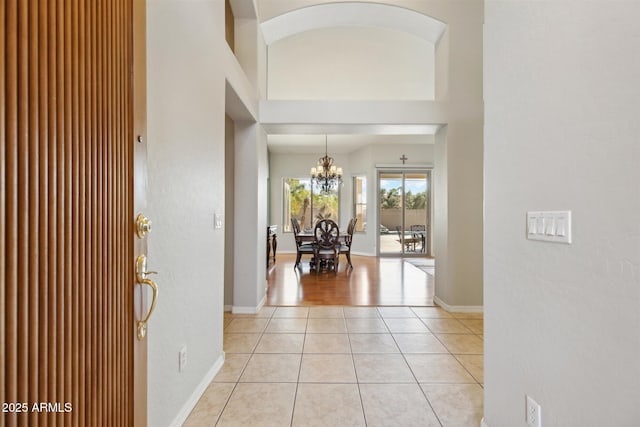 foyer featuring light tile patterned floors and an inviting chandelier