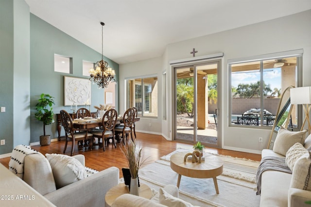 living room with vaulted ceiling, wood-type flooring, and a chandelier