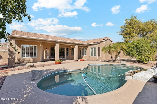 back of house with a patio