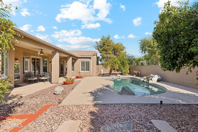 view of pool with ceiling fan and a patio