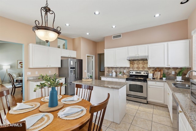 kitchen featuring pendant lighting, a center island, white cabinets, sink, and stainless steel appliances