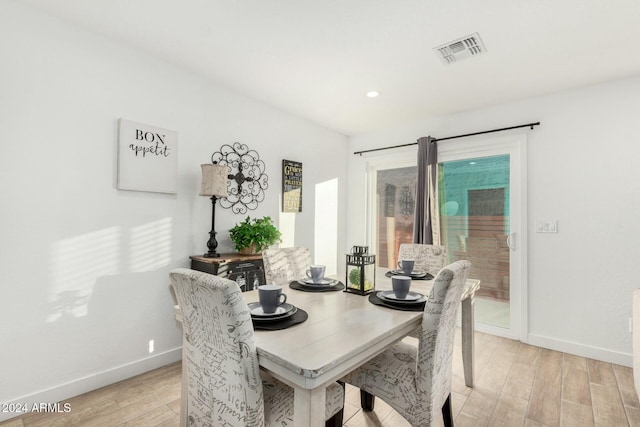 dining space featuring light wood-type flooring