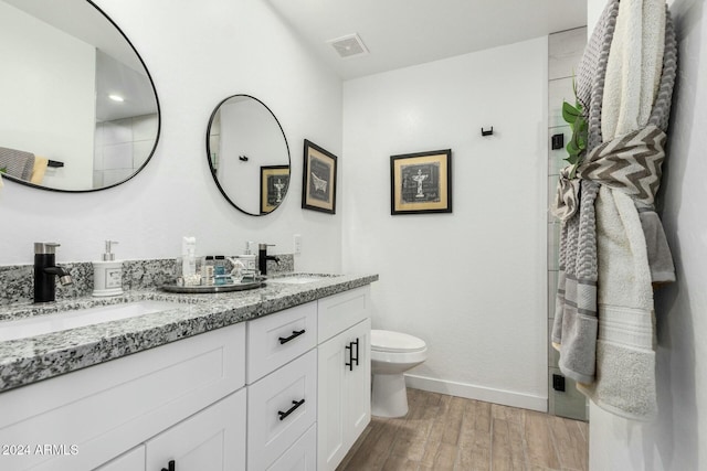 bathroom featuring hardwood / wood-style floors, vanity, and toilet