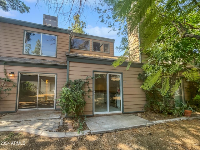 rear view of house with a patio and cooling unit