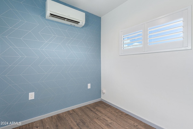 spare room with hardwood / wood-style flooring and a wall mounted AC