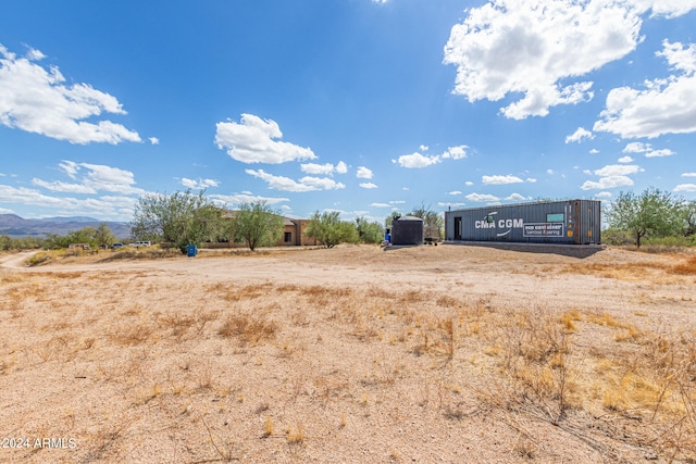 view of yard with a rural view