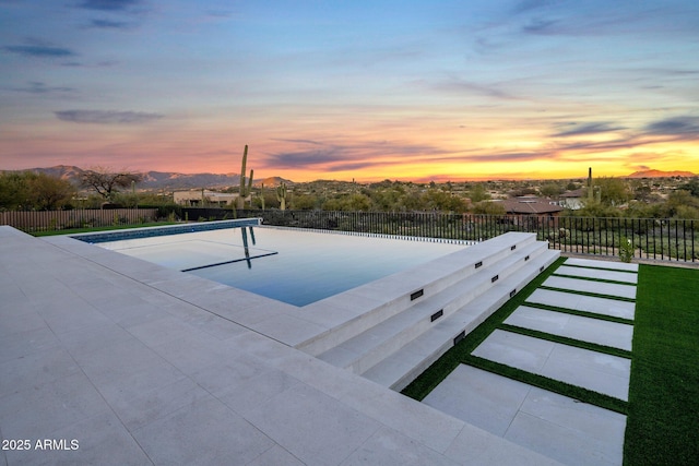 pool at dusk with a mountain view