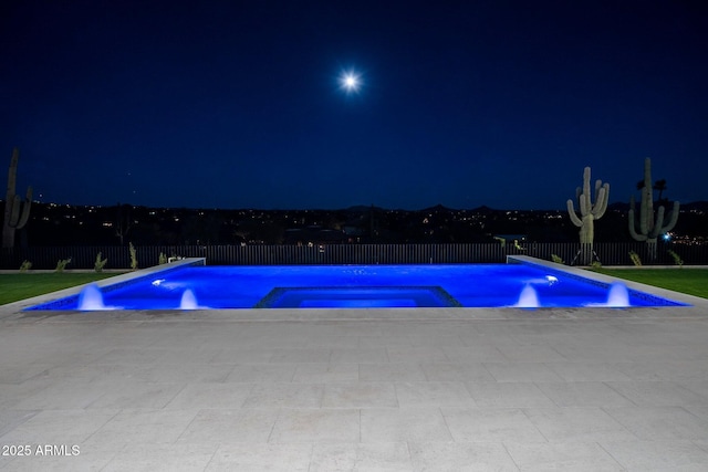 view of pool at night