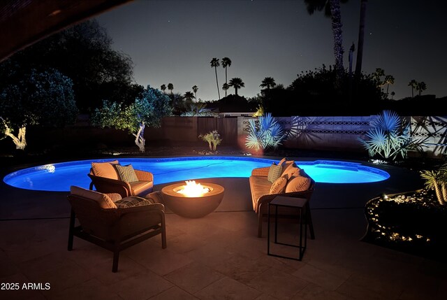 202 N Florence Ave, Litchfield Park, AZ 85340 - pool at night featuring a fire pit and a patio