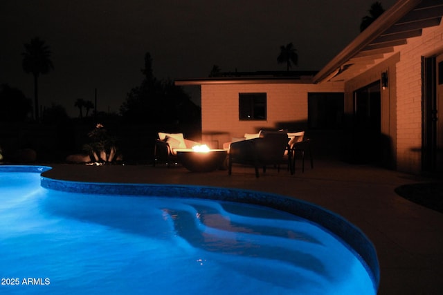 202 N Florence Ave, Litchfield Park, AZ 85340 - pool at twilight with a patio area, an outdoor pool, and a fire pit