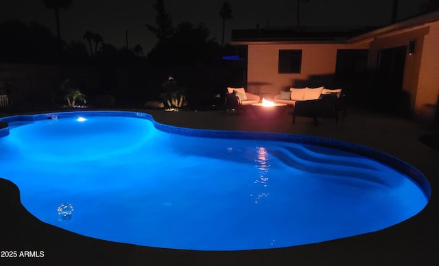 202 N Florence Ave, Litchfield Park, AZ 85340 - pool at twilight featuring a patio area, an outdoor living space with a fire pit, and an outdoor pool