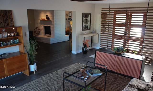 202 N Florence Ave, Litchfield Park, AZ 85340 - living area with wood finished floors, plenty of natural light, a fireplace, and baseboards