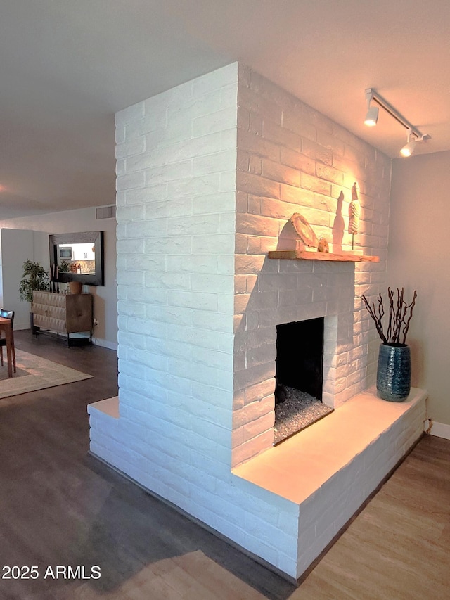 202 N Florence Ave, Litchfield Park, AZ 85340 - living room featuring a fireplace, wood finished floors, track lighting, and baseboards