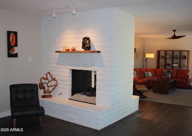 202 N Florence Ave, Litchfield Park, AZ 85340 - living room with rail lighting, wood finished floors, and a brick fireplace
