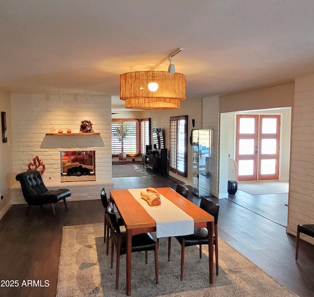 202 N Florence Ave, Litchfield Park, AZ 85340 - dining room with wood finished floors, a multi sided fireplace, baseboards, and french doors
