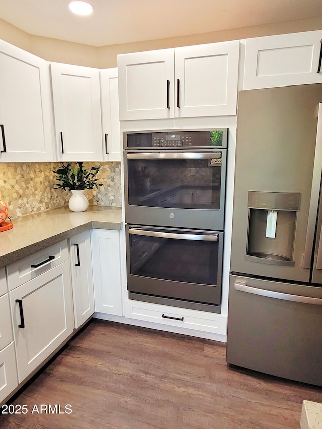 202 N Florence Ave, Litchfield Park, AZ 85340 - kitchen with appliances with stainless steel finishes, white cabinetry, decorative backsplash, wood finished floors, and recessed lighting