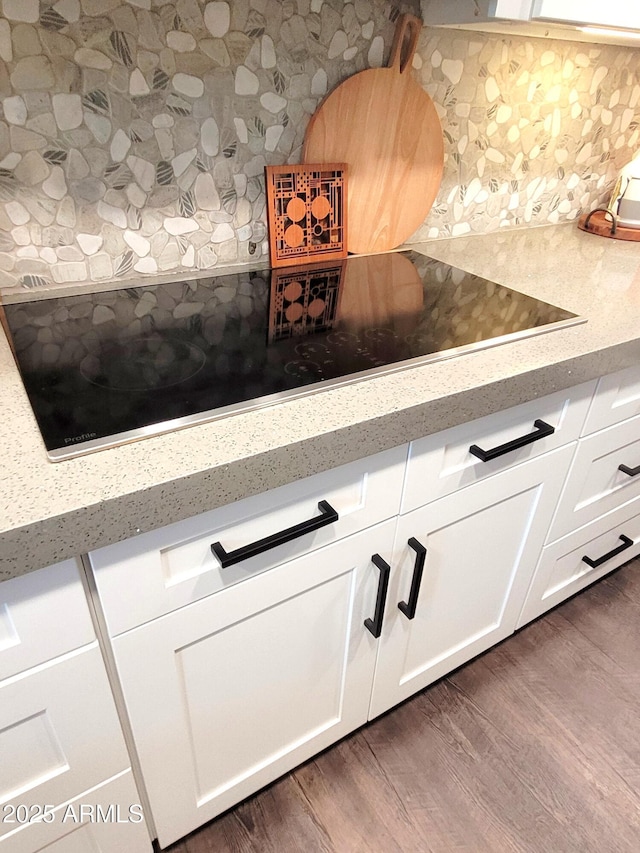 202 N Florence Ave, Litchfield Park, AZ 85340 - kitchen view of decorative backsplash, dark wood-style flooring, white cabinets, and light stone countertops