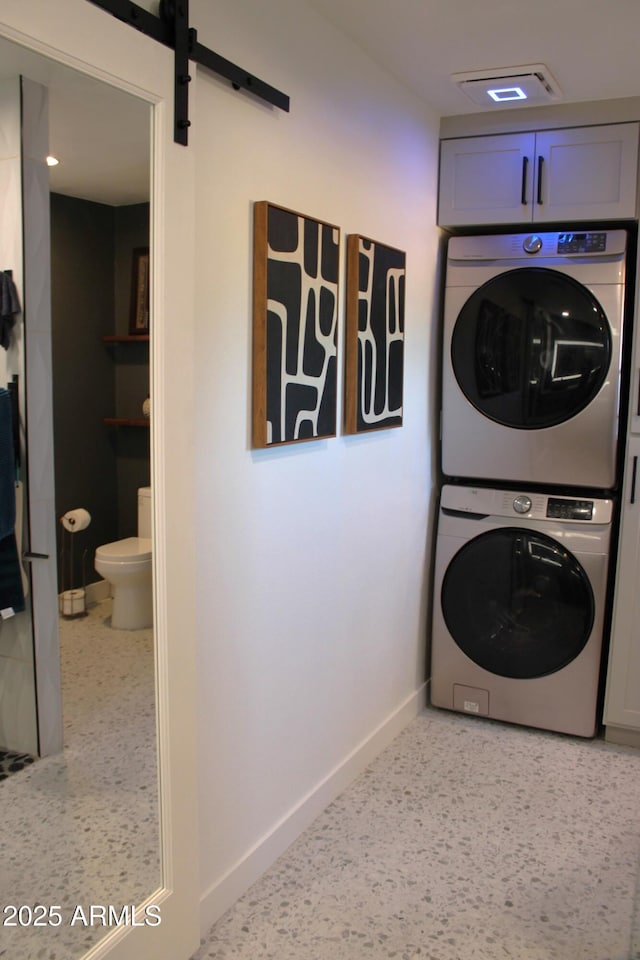 202 N Florence Ave, Litchfield Park, AZ 85340 - washroom with estacked washer and dryer, cabinet space, and baseboards
